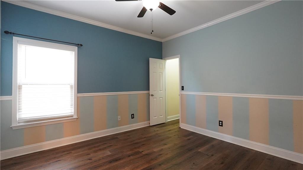548 Myrtle Trace Lane Suwanee, GA 30024 - Photo 51 of 87 an empty room with wooden floor cabinet and windows