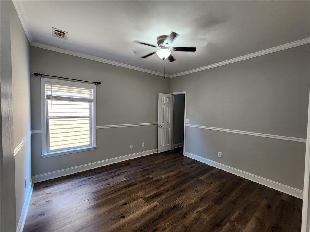 548 Myrtle Trace Lane Suwanee, GA 30024 - Photo 52 of 87 a view of an empty room with wooden floor and a window