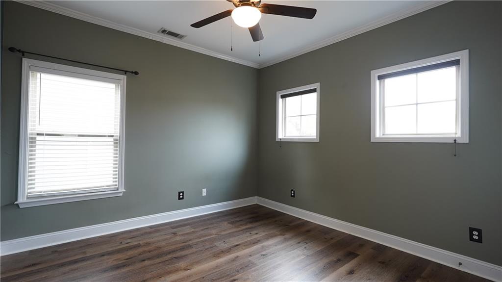 548 Myrtle Trace Lane Suwanee, GA 30024 - Photo 53 of 74 a view of an empty room with wooden floor and a window