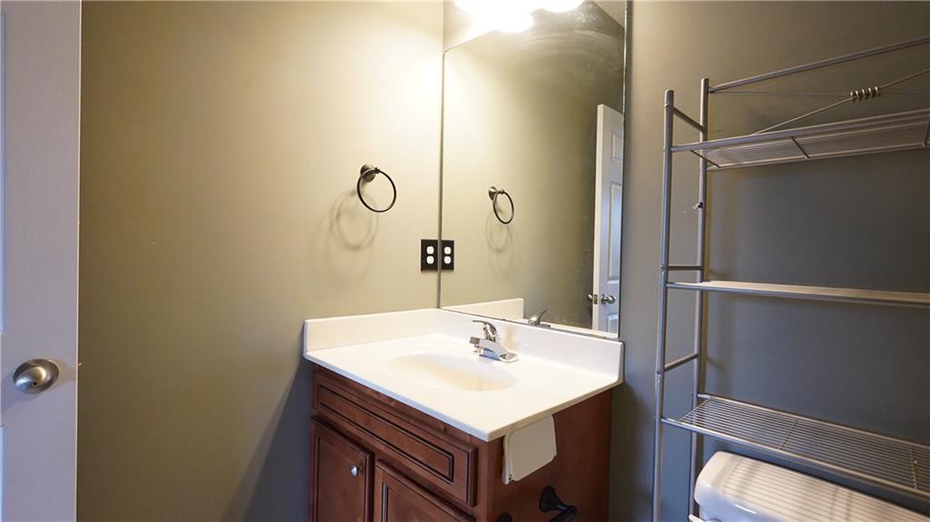 548 Myrtle Trace Lane Suwanee, GA 30024 - Photo 56 of 74 a bathroom with a sink vanity and a mirror