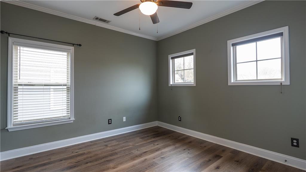 548 Myrtle Trace Lane Suwanee, GA 30024 - Photo 57 of 87 a view of an empty room with wooden floor and a window