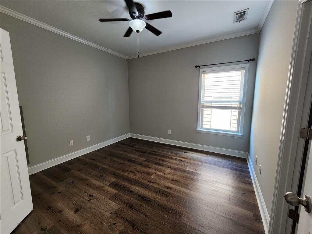 548 Myrtle Trace Lane Suwanee, GA 30024 - Photo 59 of 87 a view of an empty room with wooden floor and a window