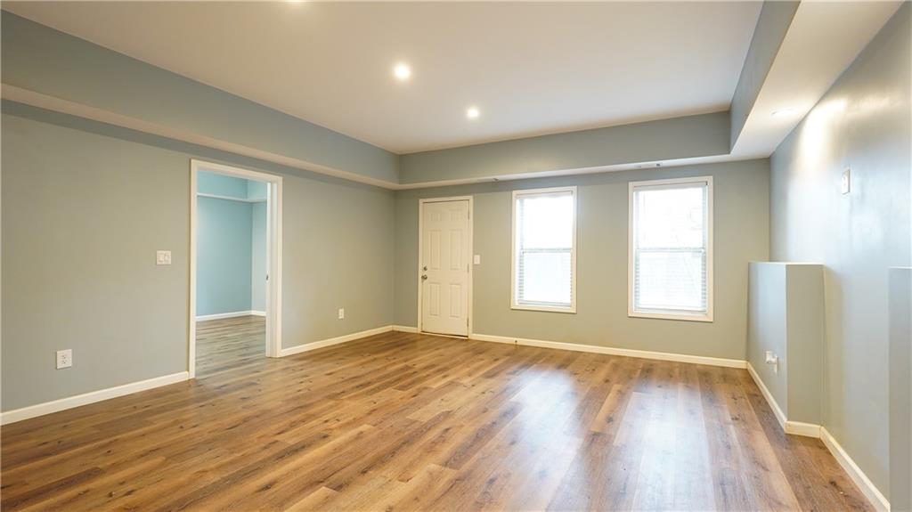 548 Myrtle Trace Lane Suwanee, GA 30024 - Photo 60 of 74 a view of an empty room with wooden floor and a window