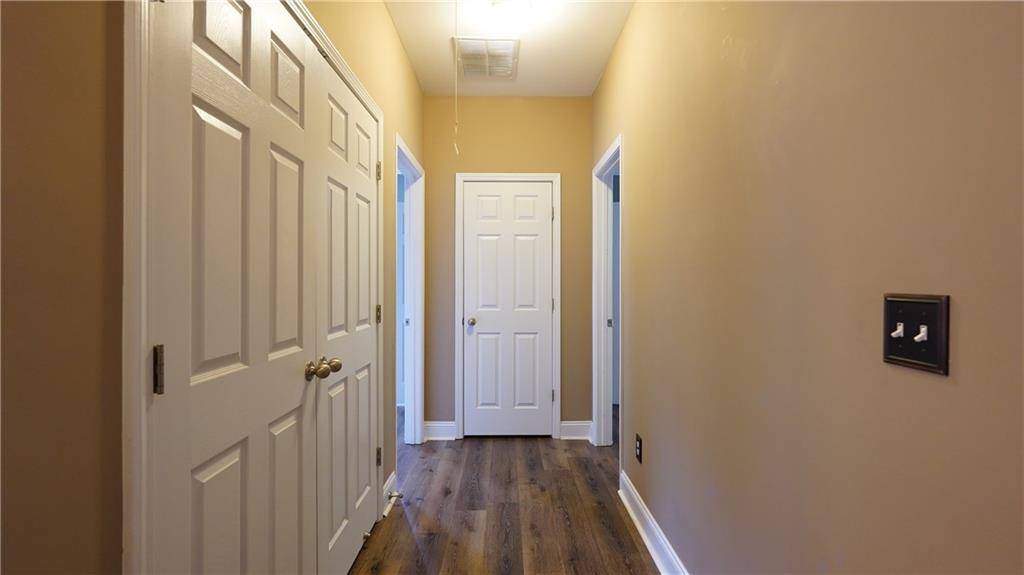 548 Myrtle Trace Lane Suwanee, GA 30024 - Photo 62 of 87 a view of a hallway with wooden floor and staircase