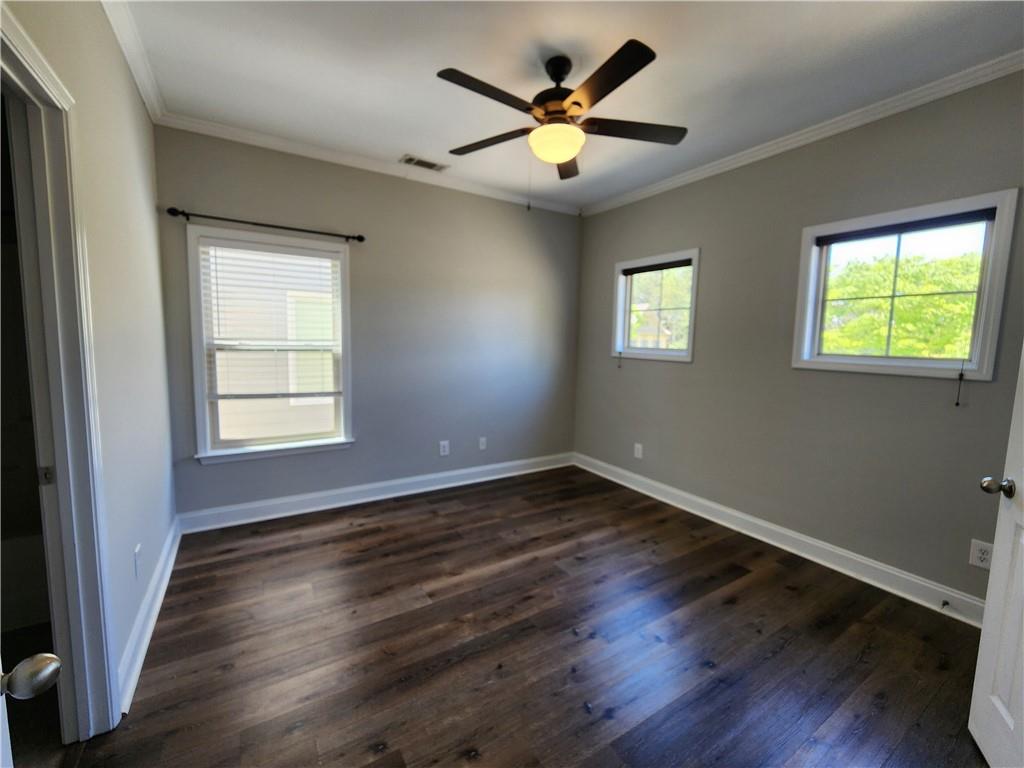 548 Myrtle Trace Lane Suwanee, GA 30024 - Photo 64 of 87 a view of an empty room with wooden floor and a window