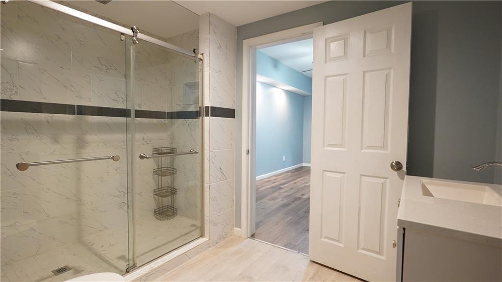 548 Myrtle Trace Lane Suwanee, GA 30024 - Photo 65 of 74 a bathroom with a shower and a sink