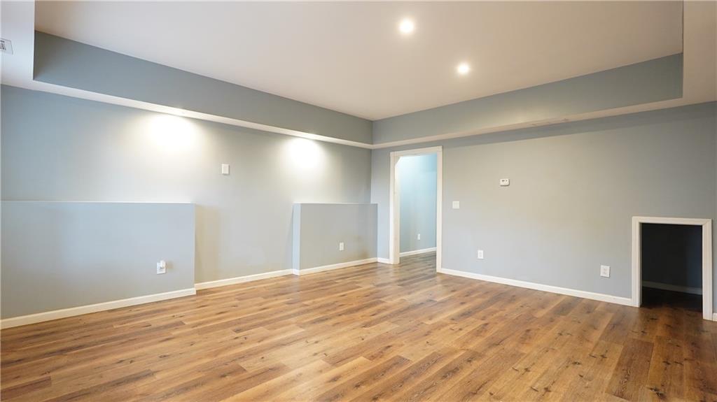 548 Myrtle Trace Lane Suwanee, GA 30024 - Photo 72 of 87 a view of an empty room with wooden floor