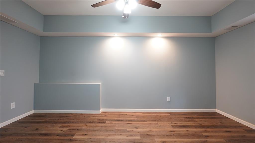 548 Myrtle Trace Lane Suwanee, GA 30024 - Photo 73 of 87 a view of an empty room with wooden floor
