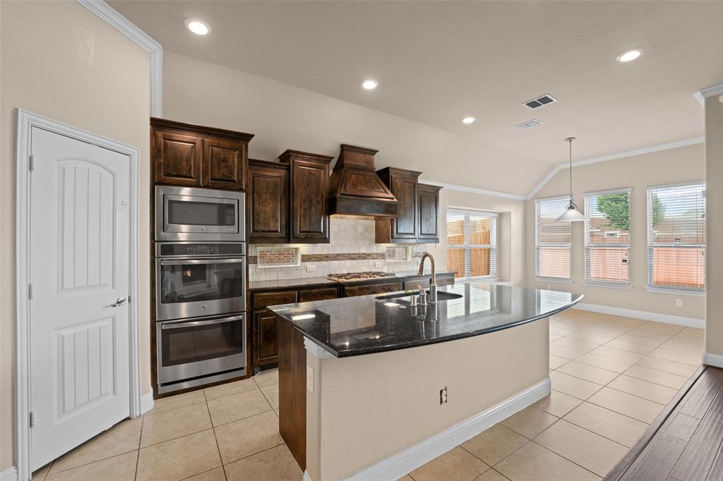 600 Fishback Circle Plano, TX 75074 - Photo 9 of 38 a kitchen with stainless steel appliances granite countertop a stove and a refrigerator