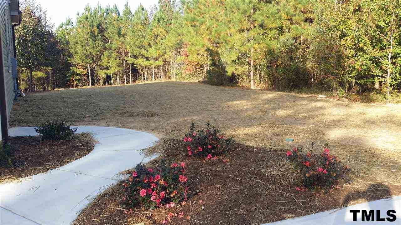 665 Tilghman Road Coats, NC 27521 - Photo 22 of 25 a view of a pathway with a yard