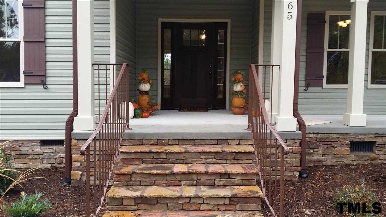 665 Tilghman Road Coats, NC 27521 - Photo 4 of 25 a front view of a house with a yard