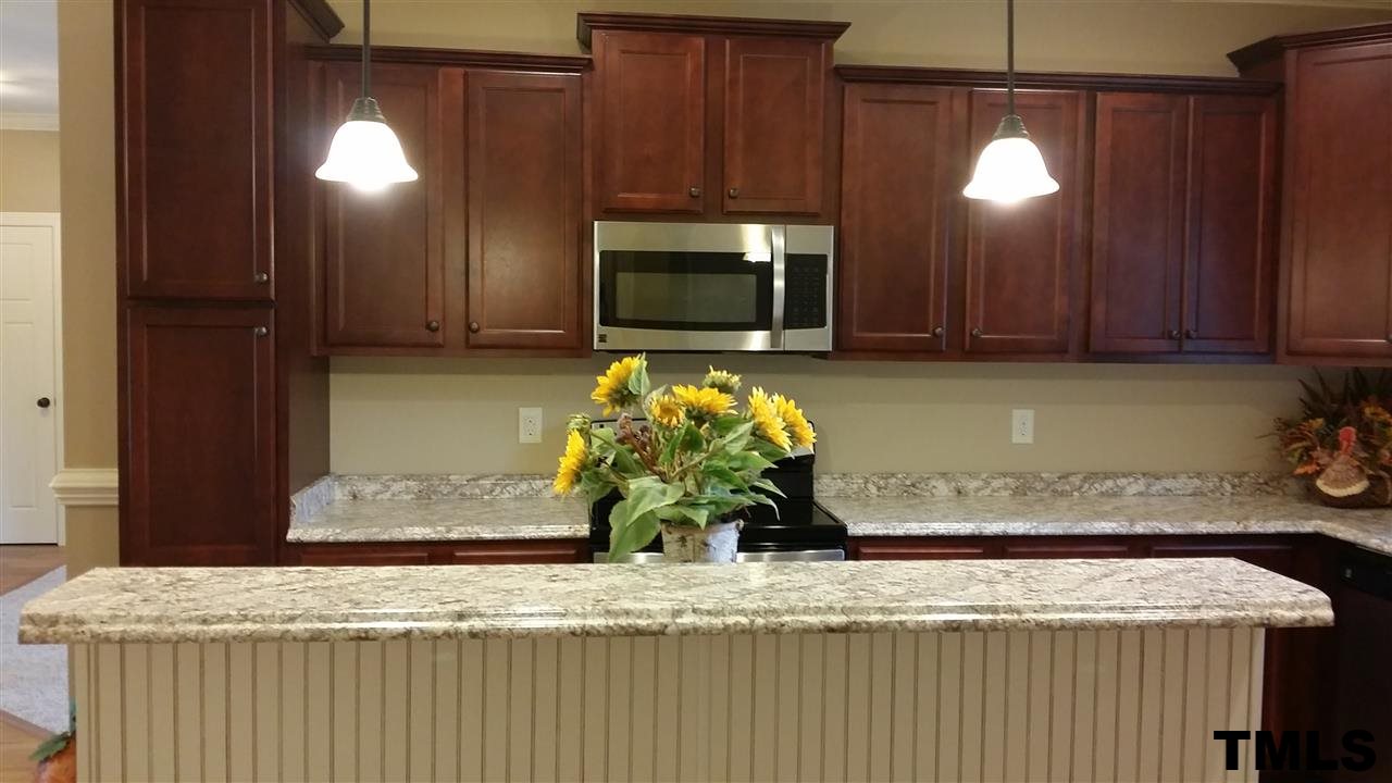 665 Tilghman Road Coats, NC 27521 - Photo 10 of 25 a bathroom with a granite countertop sink and a mirror