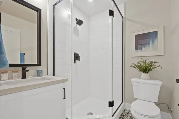 a bathroom with a toilet sink and shower