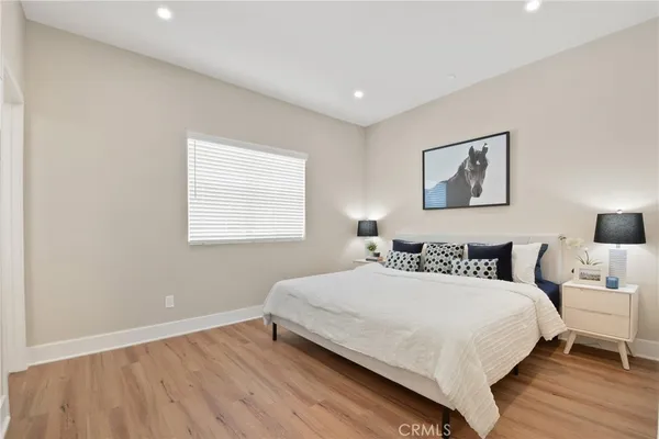 a bedroom with a bed and a night stand