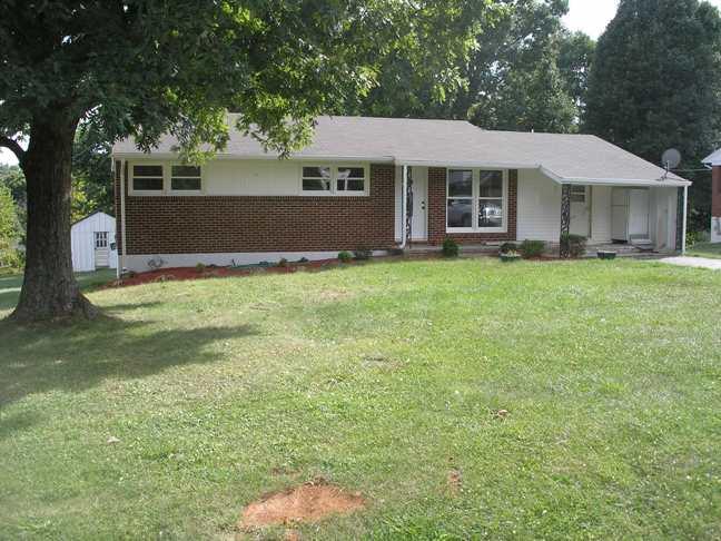 1201 Scuffling Hill Road Rocky Mount, VA 24151 - Photo 1 of 5 a front view of a house with a garden