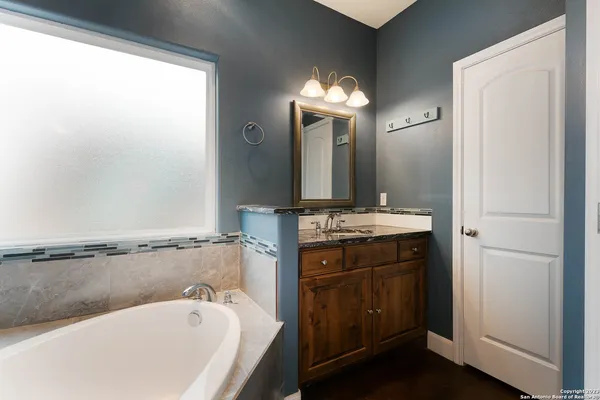 a bathroom with a bathtub and a sink