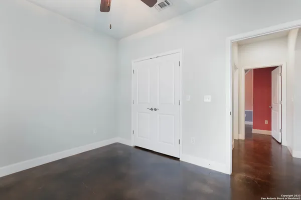 a view of a room with wooden floor
