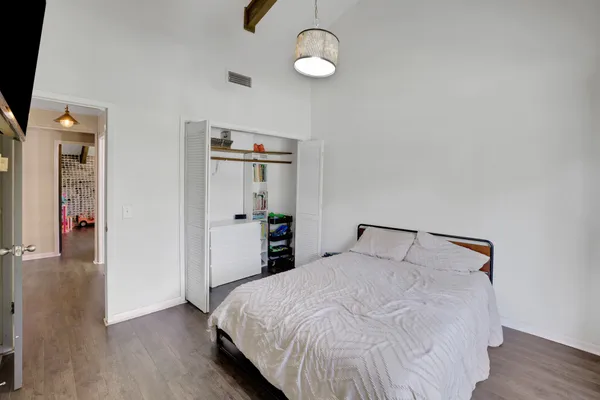 a bedroom with a bed and a window
