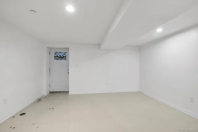an empty room with a empty space and windows