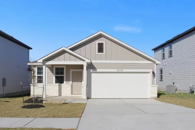 a front view of a house with a garage