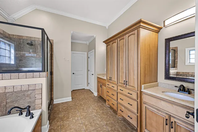 a bathroom with a double vanity sink a mirror and a bathtub