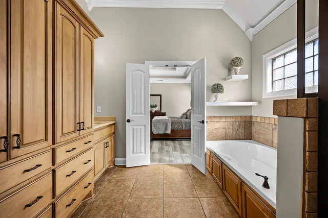 a bathroom with a tub and a view of bathroom