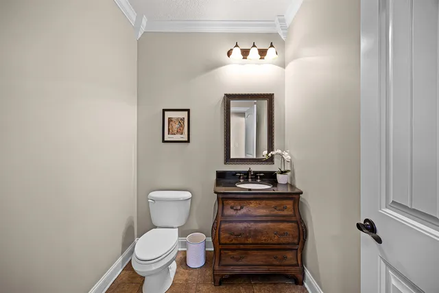 a bathroom with a toilet a sink and vanity