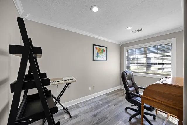 a view of a workspace with furniture and a window