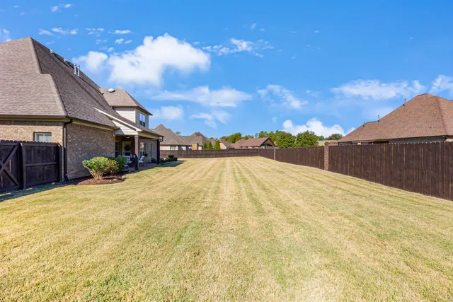 an aerial view of a house with swimming pool and outdoor seating
