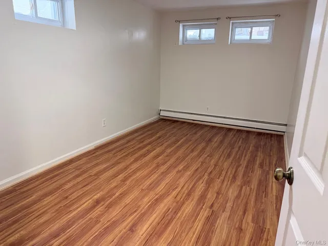 a view of room with wooden floor and window