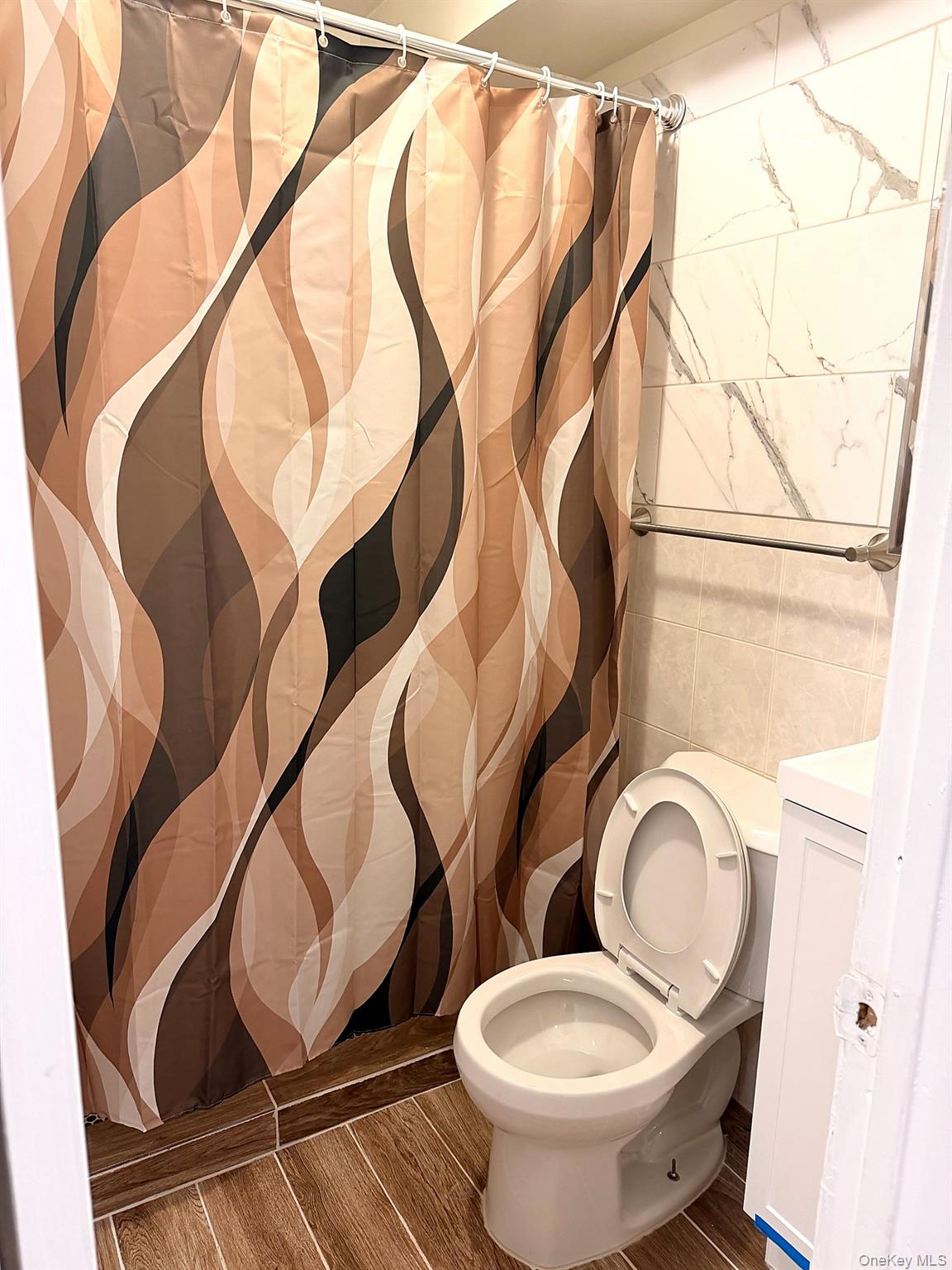 153-17 110th Road, Unit 1R Queens, NY 11433 - Photo 14 of 14 a bathroom with a toilet and a mirror