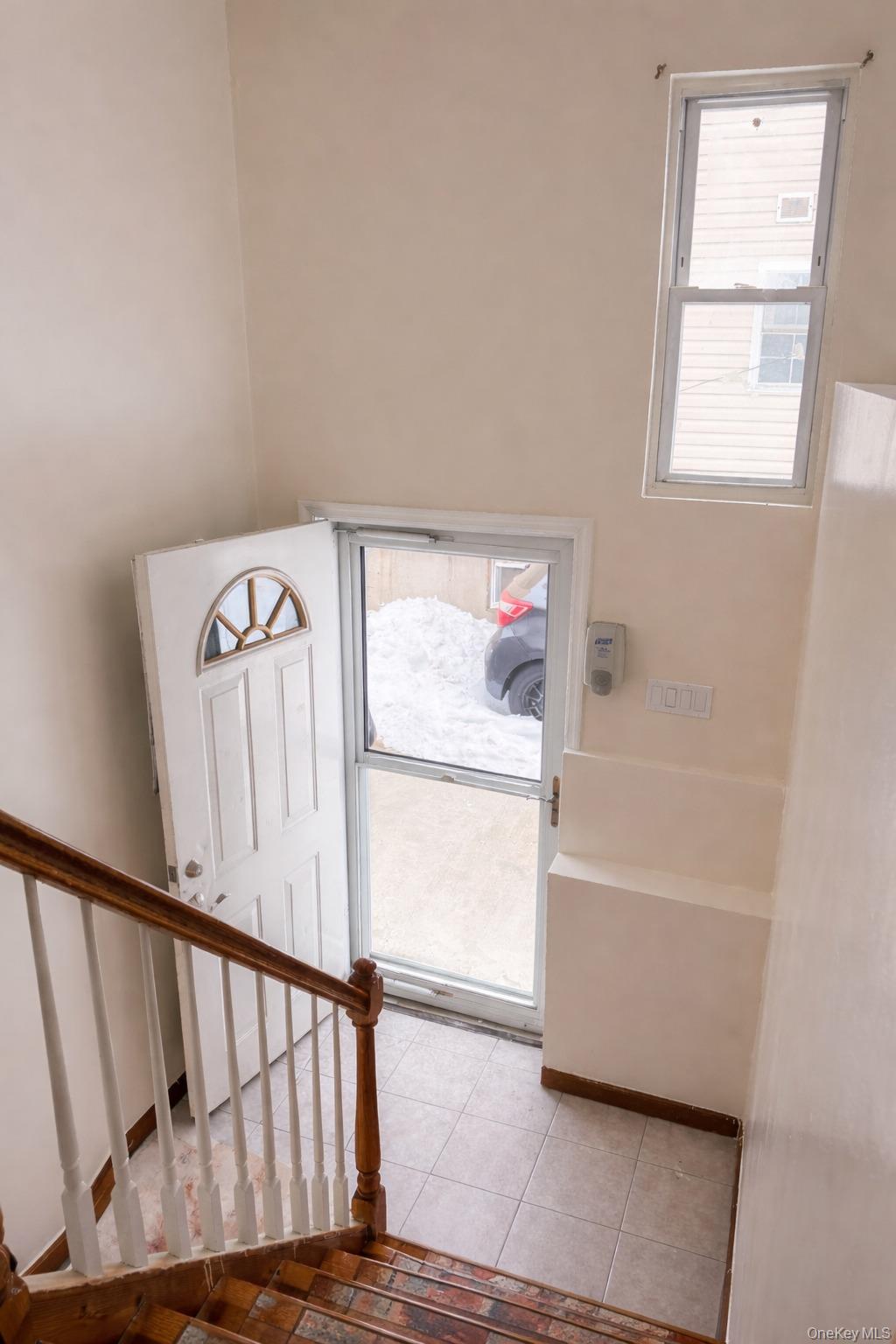 153-17 110th Road, Unit 1R Queens, NY 11433 - Photo 3 of 14 a view of entryway with a window and stairs