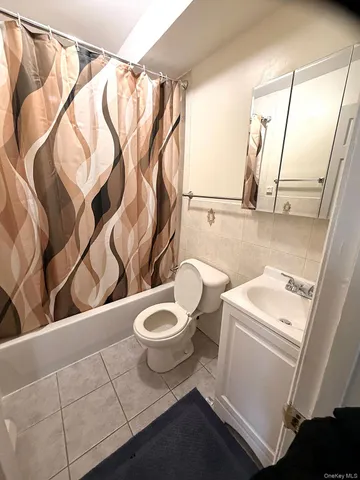 a bathroom with a sink a toilet and a shower