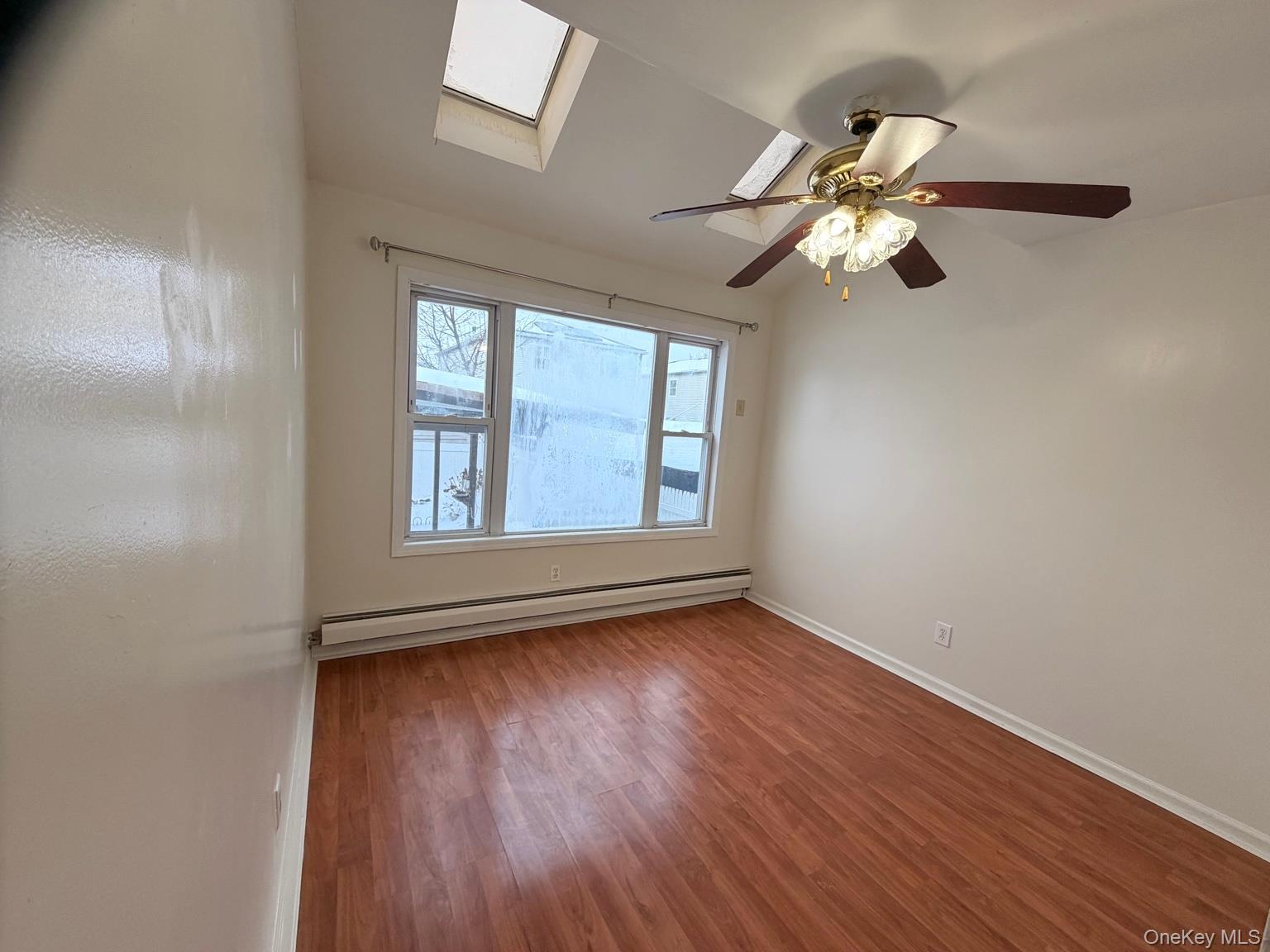 153-17 110th Road, Unit 1R Queens, NY 11433 - Photo 8 of 14 a view of empty room with wooden floor and fan