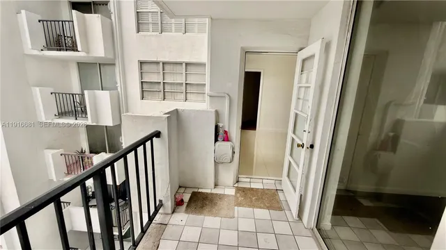a walk in closet with wooden floor
