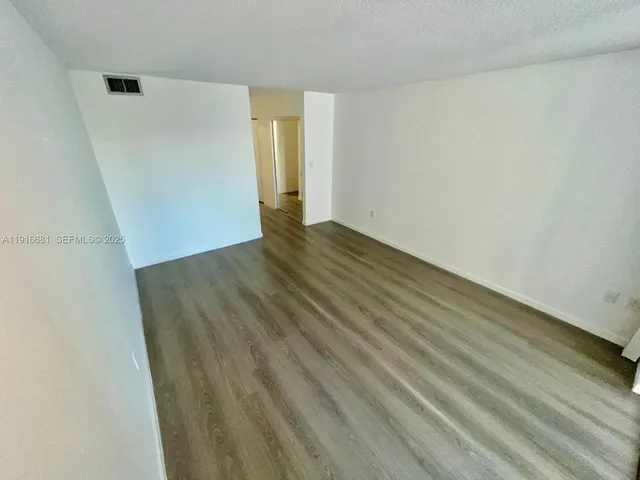 a view of swimming pool with chairs and potted plants