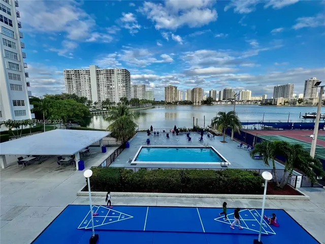 a view of a patio with table and chairs potted plants