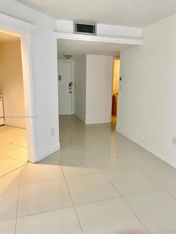 a view of a hallway to rooms