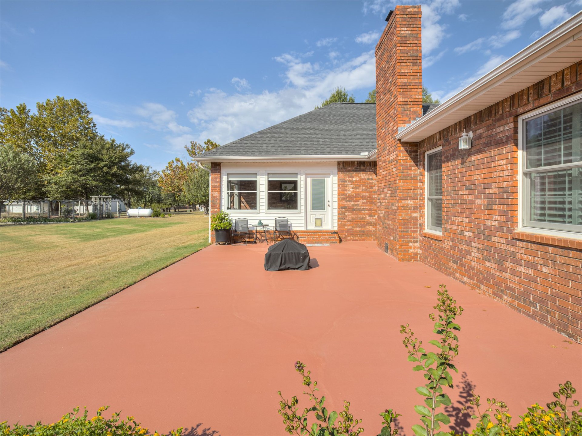 119 Mainsail Road Stigler, OK 74462 - Photo 41 of 52 Brick exterior featuring a painted patio, white trim, and a shingled roof