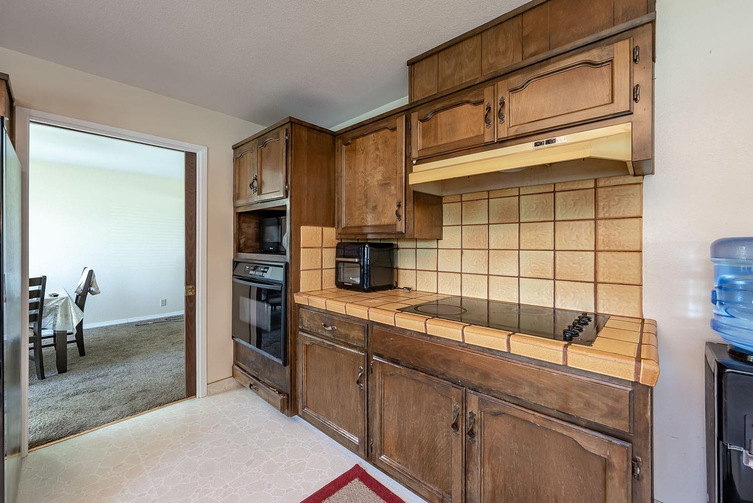 653 Meadow Lane Lemoore, CA 93245 - Photo 12 of 43 a kitchen with a sink cabinets and appliances