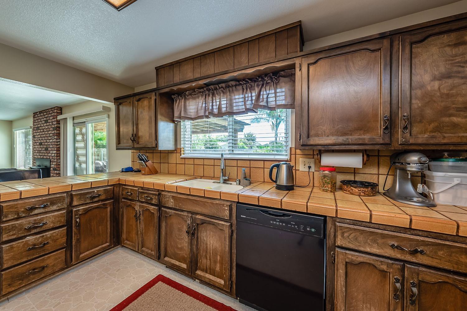 653 Meadow Lane Lemoore, CA 93245 - Photo 13 of 43 a kitchen with a sink stove and cabinets