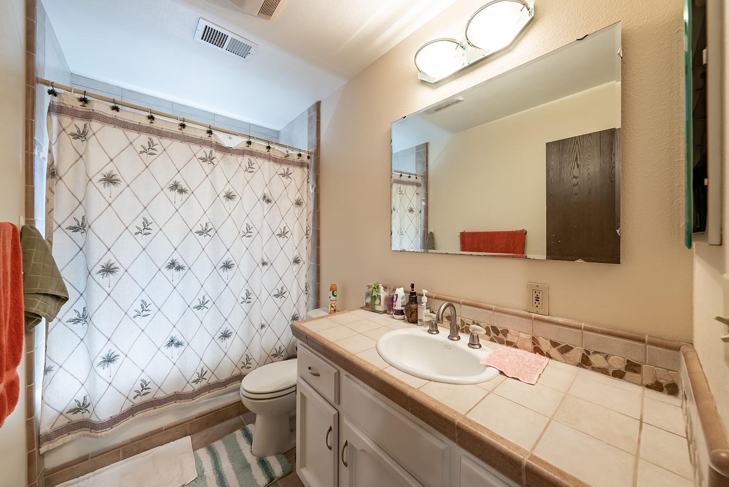 653 Meadow Lane Lemoore, CA 93245 - Photo 18 of 43 a bathroom with a sink toilet and shower