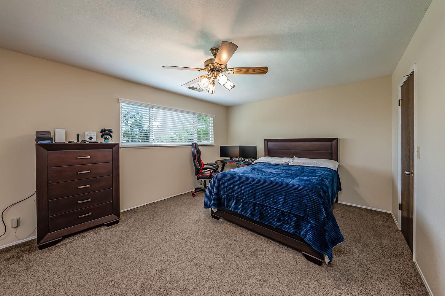 653 Meadow Lane Lemoore, CA 93245 - Photo 20 of 43 a bedroom with a bed and window