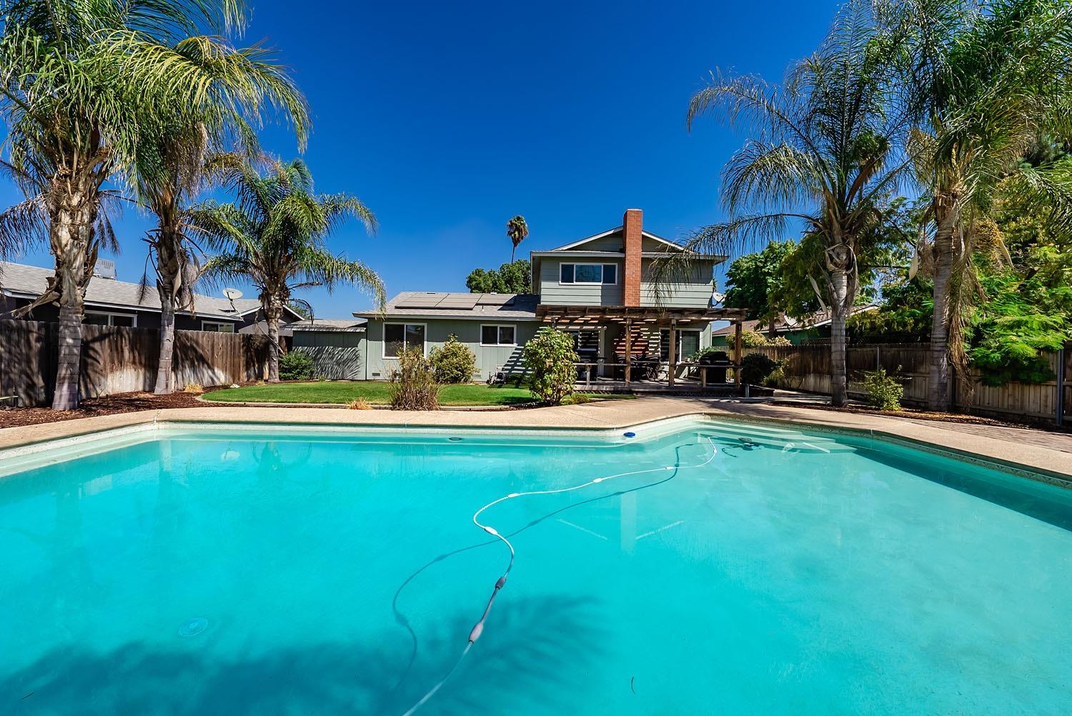 653 Meadow Lane Lemoore, CA 93245 - Photo 2 of 43 a view of swimming pool with lawn chairs and plants