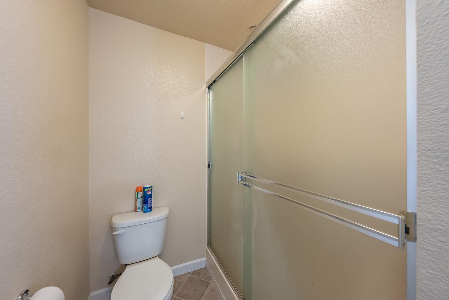 653 Meadow Lane Lemoore, CA 93245 - Photo 21 of 43 a white toilet sitting next to a bathroom sink