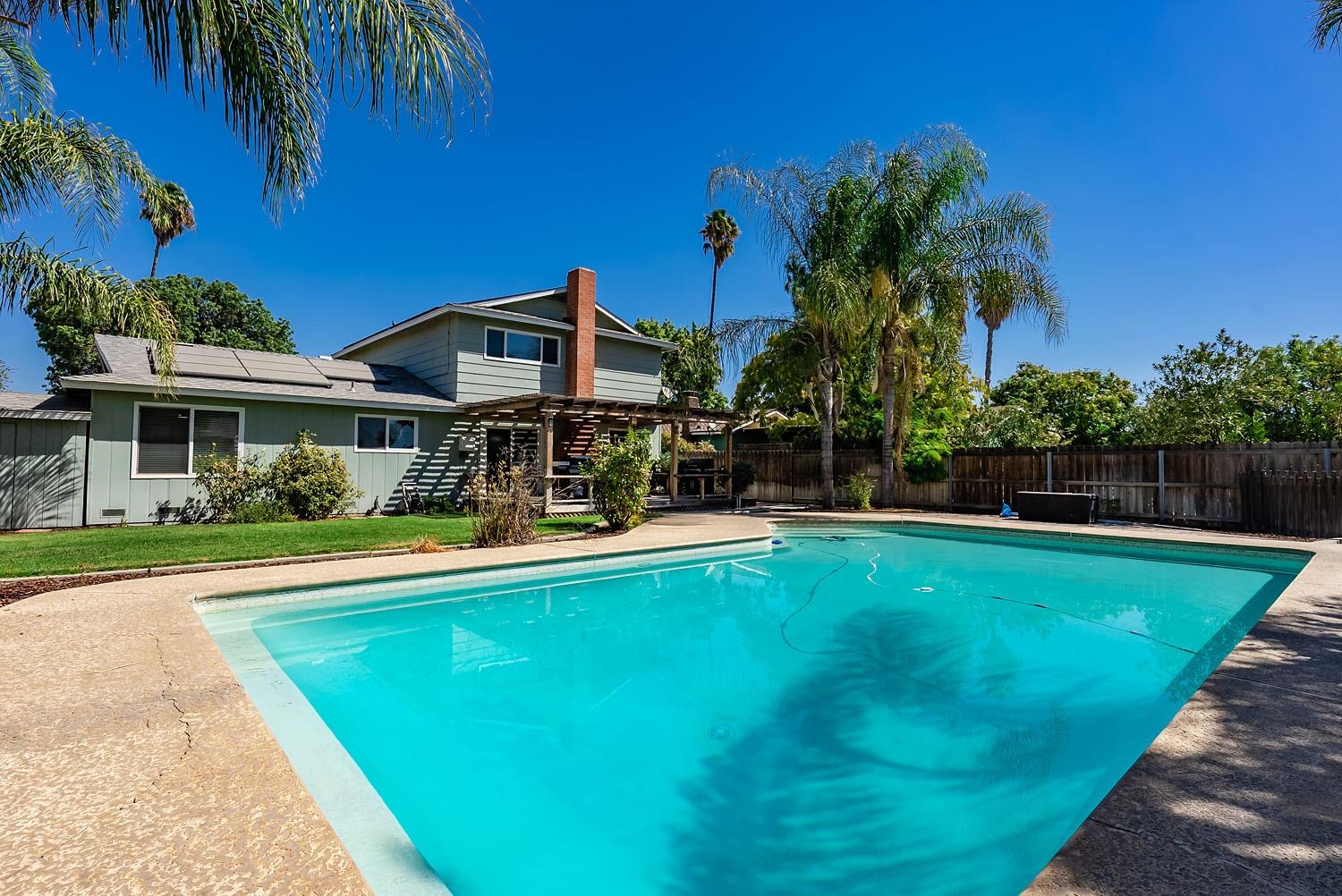 653 Meadow Lane Lemoore, CA 93245 - Photo 27 of 43 a view of a house with swimming pool and a yard
