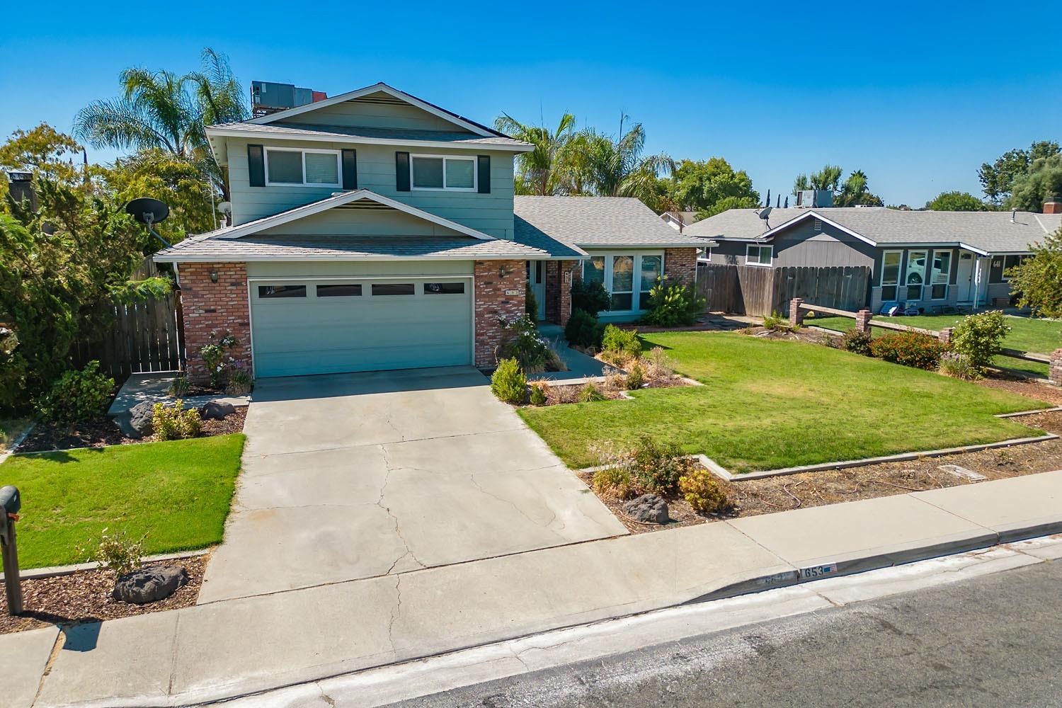 653 Meadow Lane Lemoore, CA 93245 - Photo 34 of 43 a front view of a house with garden