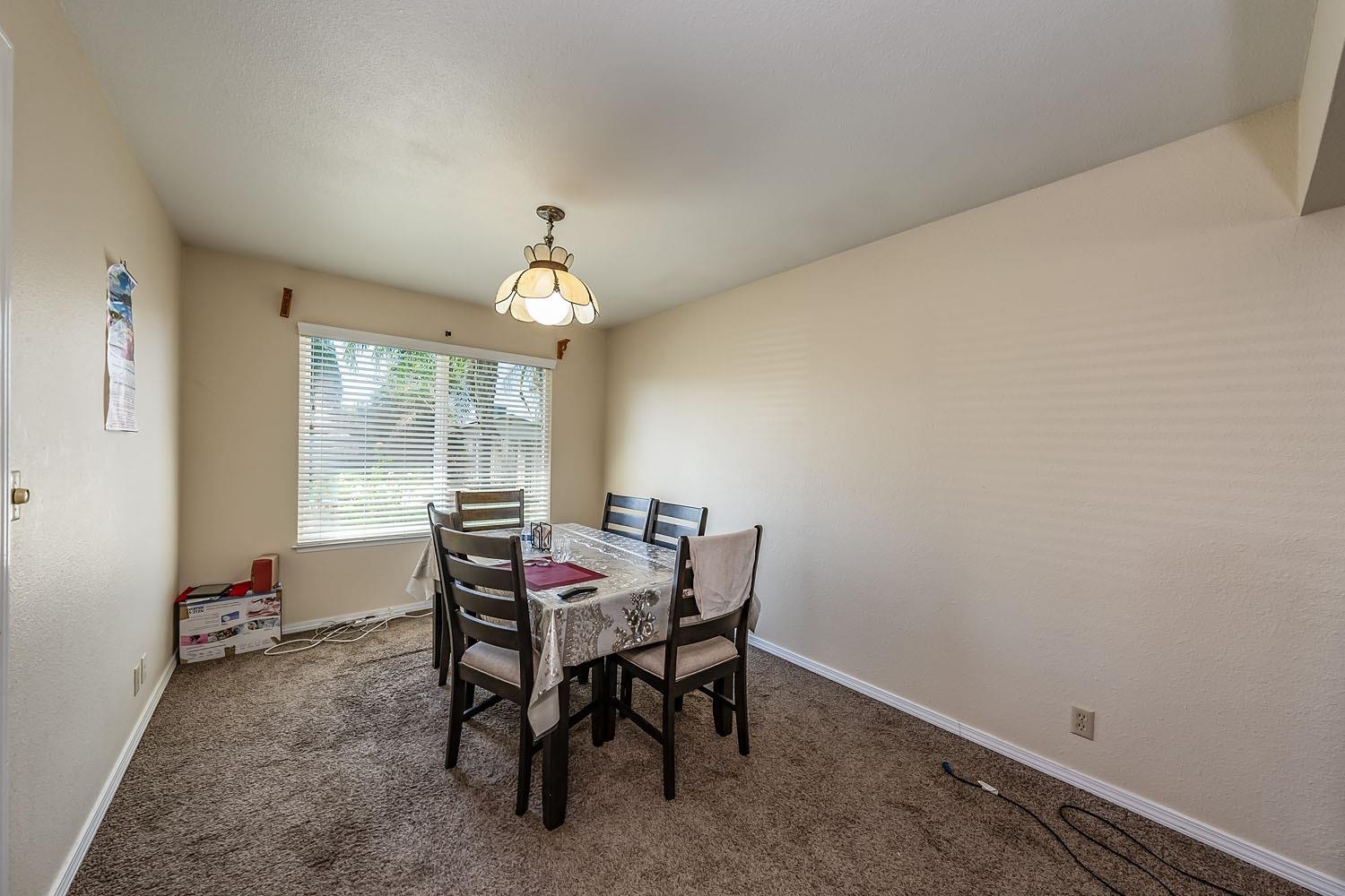 653 Meadow Lane Lemoore, CA 93245 - Photo 8 of 43 a view of a dining room with furniture and a window