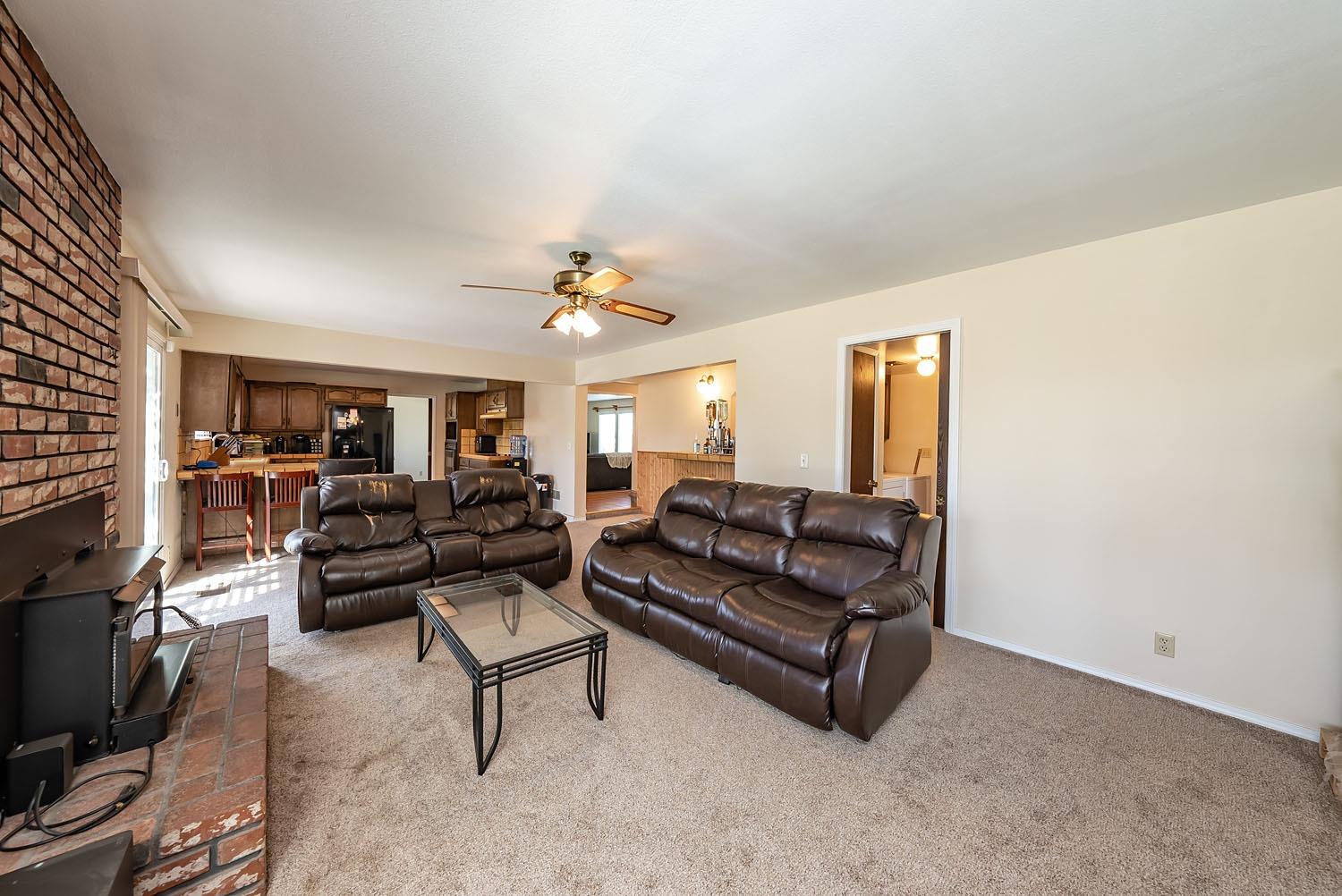 653 Meadow Lane Lemoore, CA 93245 - Photo 10 of 43 a living room with furniture and a flat screen tv