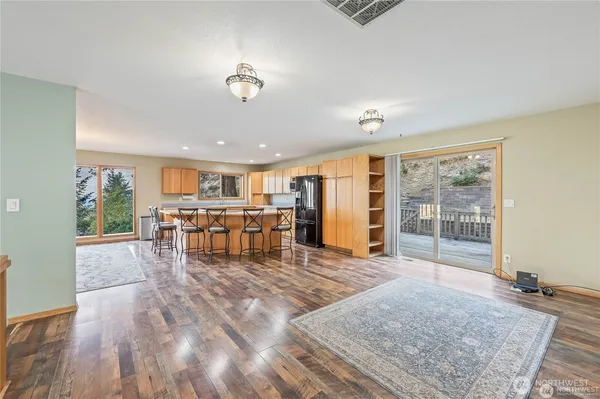 a living room with furniture and kitchen view